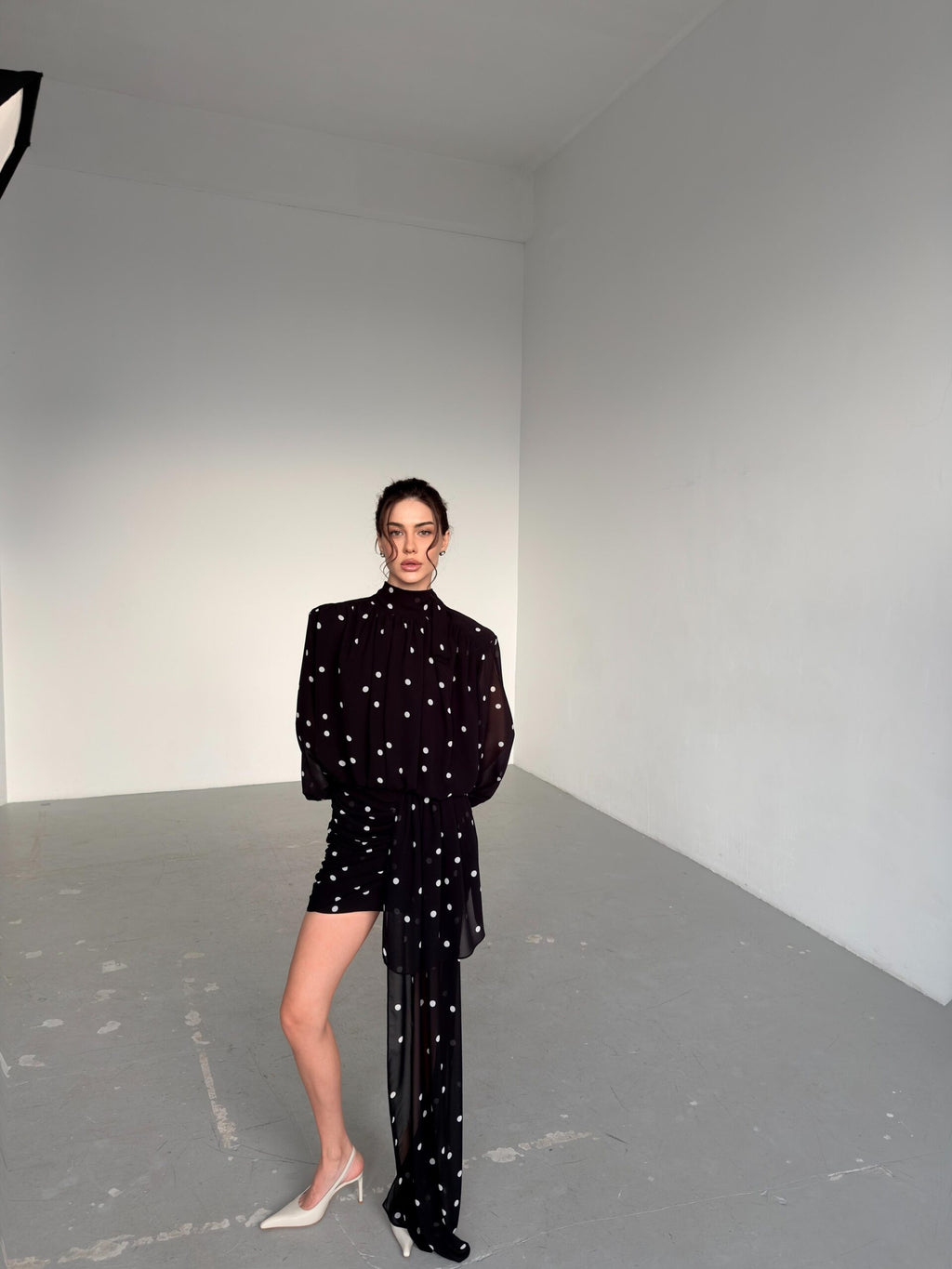 Dress with drapery and voluminous shoulders