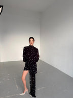 Dress with drapery and voluminous shoulders