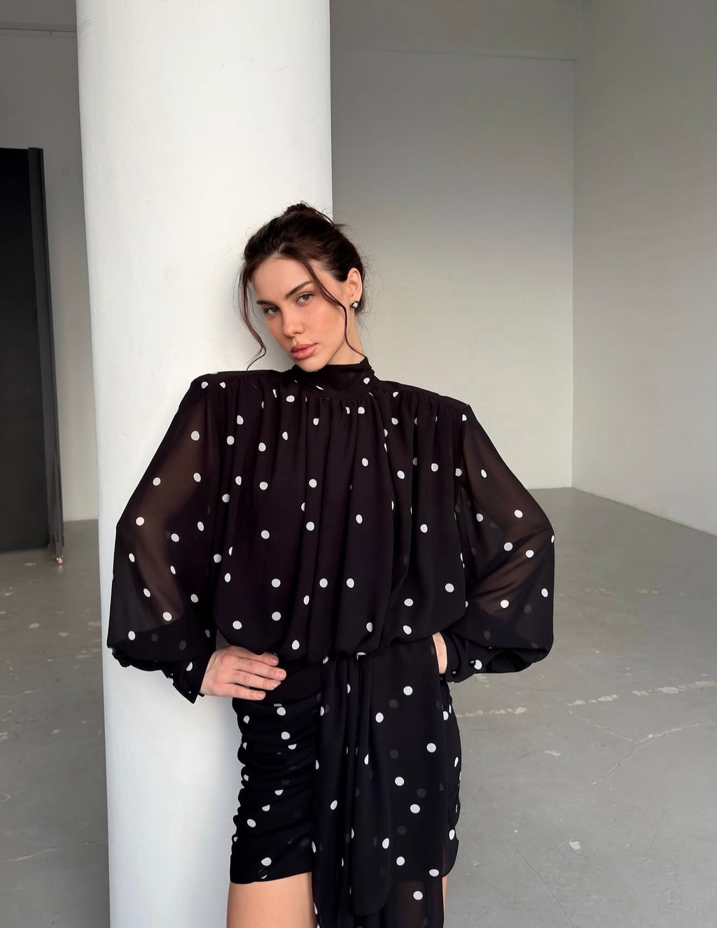 Dress with drapery and voluminous shoulders