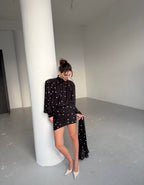 Dress with drapery and voluminous shoulders