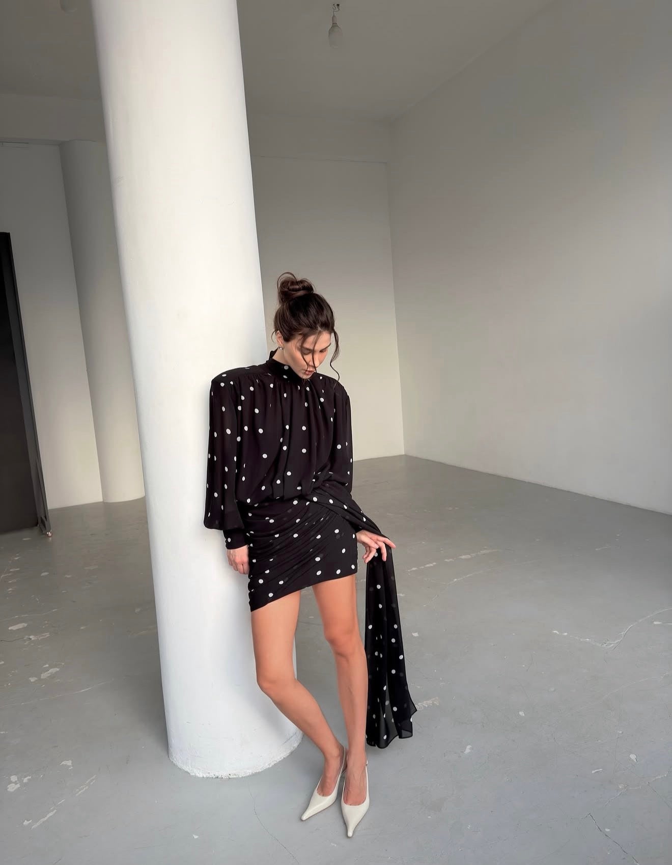 Dress with drapery and voluminous shoulders
