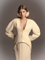 The jacket is fitted with slits at the back and a bow