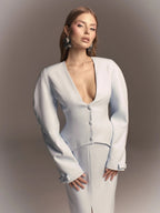The jacket is fitted with slits at the back and a bow